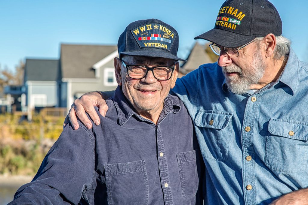 Two veterans getting a discount on their hearing aids